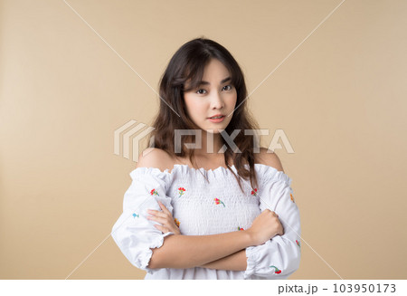 Portrait young Asian woman in cute dress isolated on brown background. 103950173