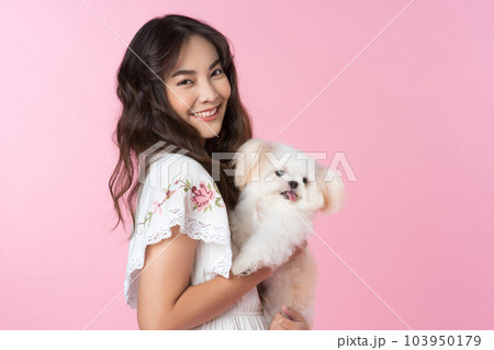 Young Asian woman with her dog chihuahua hug and feeling happy shoot in isolated on pink background Young Asian woman with her dog chihuahua hug and feeling happy shoot in isolated on pink background 103950179