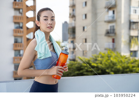 Young Asian woman resting after running exercise.outdoor exercise fitness concept Young Asian woman resting after running exercise.outdoor exercise fitness concept 103950224