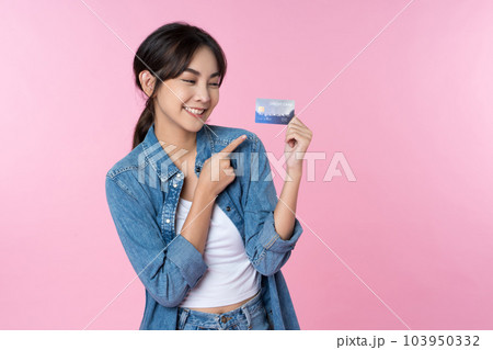 Young Asian woman showing blank credit card in formal suit, isolated pink background 103950332
