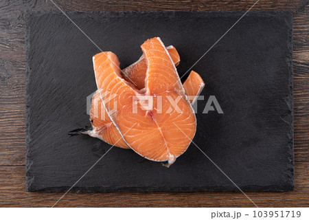 Top view of salmon steaks on a mica serving board. Top view of salmon steaks on a mica serving board. 103951719