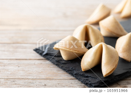 Traditional fortune cookies on wooden table Traditional fortune cookies on wooden table 103951966