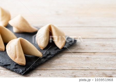 Traditional fortune cookies on wooden table 103951968