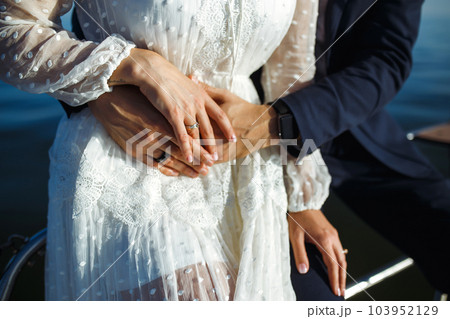 Bride and groom's hands with elegant wedding rings. Wedding details. Together. Wedding day. 103952129
