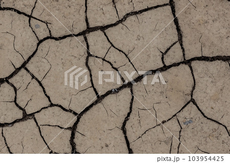 Crack. Dry soil. The global shortage of water on the planet. Global warming and greenhouse effect concept. The parched soil. Baraje. Soil drought cracked texture. Crack. Dry soil. The global shortage of water on the planet. Global warming and greenhouse effect concept. The parched soil. Baraje. Soil drought cracked texture. 103954425