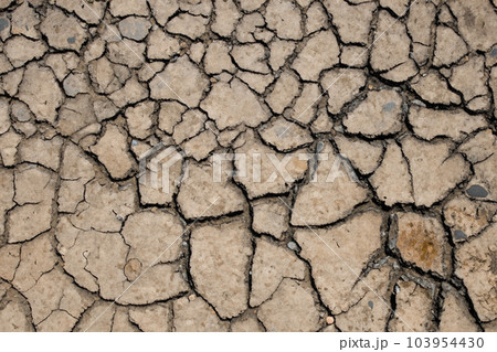 Crack. Dry soil. The global shortage of water on the planet. Global warming and greenhouse effect concept. The parched soil. Baraje. Soil drought cracked texture. Crack. Dry soil. The global shortage of water on the planet. Global warming and greenhouse effect concept. The parched soil. Baraje. Soil drought cracked texture. 103954430