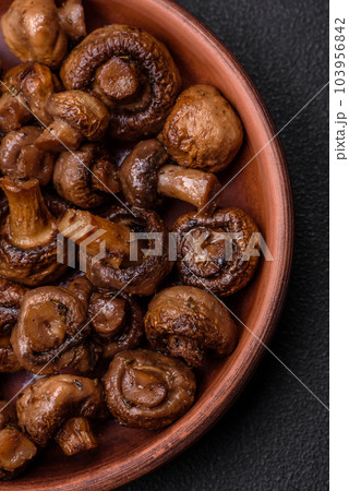 Delicious champignon mushrooms with salt, spices and herbs Delicious champignon mushrooms with salt, spices and herbs 103956842
