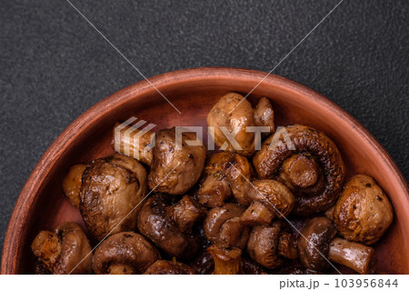 Delicious champignon mushrooms with salt, spices and herbs Delicious champignon mushrooms with salt, spices and herbs 103956844