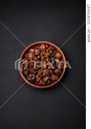 Delicious champignon mushrooms with salt, spices and herbs 103956847