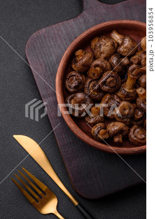 Delicious champignon mushrooms with salt, spices and herbs Delicious champignon mushrooms with salt, spices and herbs 103956854