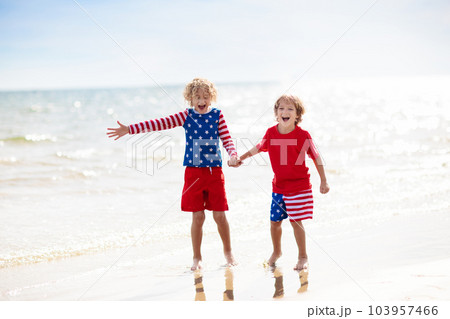 Kids with American flag on beach. 4th of July. 103957466