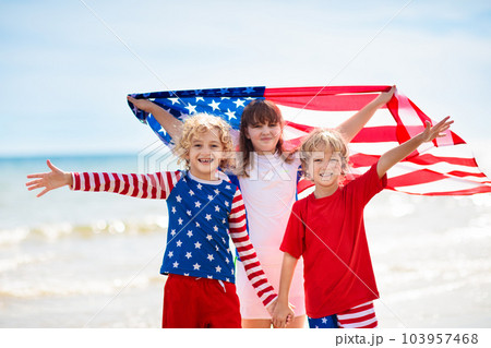 Kids with American flag on beach. 4th of July. 103957468