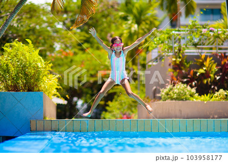 Child in swimming pool on ring toy. Kids swim. 103958177