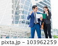 Asian businessman and businesswoman standing in the city and raise hand up to celebrate for business success. with copy space for text 103962259