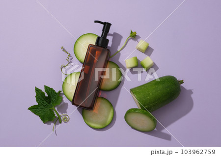 Unlabeled pump bottle dispenser put on some winter melon slices. Natural cosmetic concept. Empty label for branding mockup of Winter melon (Benincasa hispida) extract 103962759