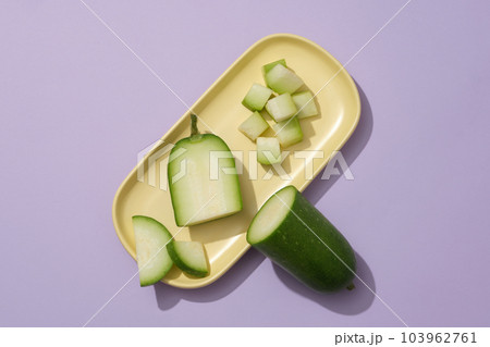 Winter melon cut in many shapes displayed on a yellow dish. Winter melon (Benincasa hispida) is a versatile addition to soups, stews, and salads 103962761