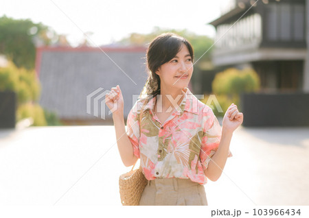 Portrait beautiful young asian woman on summer holiday vacation trip in Thailand. Young hipster female tourist sightseeing summer urban Bangkok destination. Asia summer tourism concept. Portrait beautiful young asian woman on summer holiday vacation trip in Thailand. Young hipster female tourist sightseeing summer urban Bangkok destination. Asia summer tourism concept. 103966434