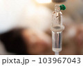 Set vitamin iv fluid intravenous drop saline drip with blur woman lying on bed in hospital room background. Medical Concept treatment emergency and injection drug infusion care chemotherapy concept. 103967043