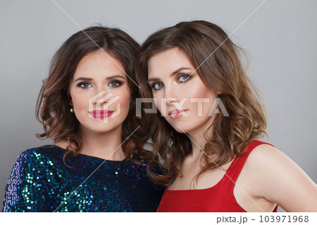 Attractive cheerful women against grey studio wall background. Fashion models with makeup 103971968
