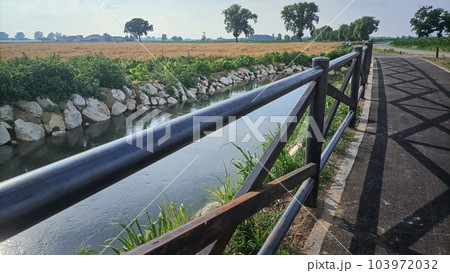 Countryside, Italy. Sportive healthy lifestyle. Beautiful non-urban track for making open air sport, running along the river Countryside, Italy. Sportive healthy lifestyle. Beautiful non-urban track for making open air sport, running along the river 103972032