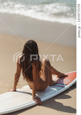 Tanned Naked Surf Girl with Surfboard, Good Day for Surfing, Sunbathing on the Beach 103973559