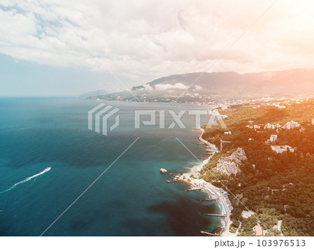 Christian church in the mountains above the sea. Temple of the Holy Archangel Michael in Oreanda. The southern coast of Crimea. Aerial view Christian church in the mountains above the sea. Temple of the Holy Archangel Michael in Oreanda. The southern coast of Crimea. Aerial view 103976513