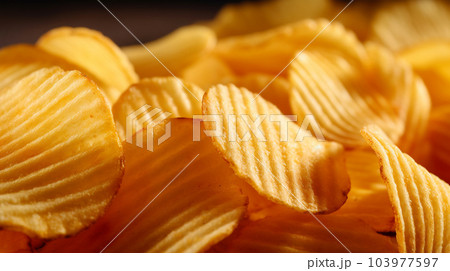 Delicious crispy potato chips, famous snack, fat food, wallpaper, texture, for banner, flyer Delicious crispy potato chips, famous snack, fat food, wallpaper, texture, for banner, flyer 103977597
