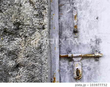 Ruined wall and old door rusty door latch 103977732