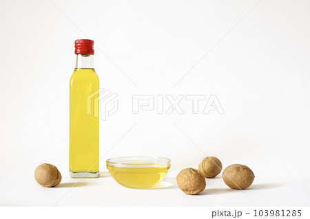 Walnut oil in bottle on white background with copy space. 103981285