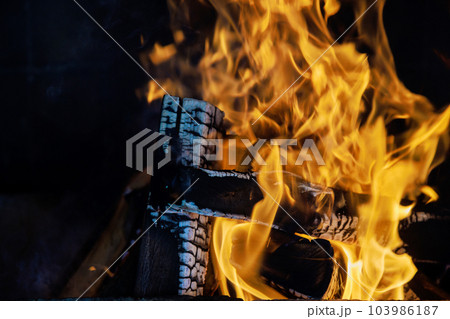 In winter months flickering flames of wood fire in traditional rural fireplace bring comfort relaxation. 103986187