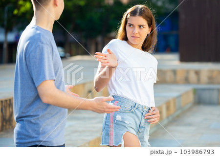 Girl gesturing stop to man flirting with her 103986793