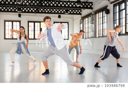 Team of young dancers training moves 103986798