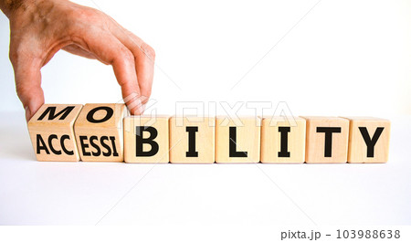Mobility and accessibility symbol. Businessman turns wooden cubes and changes the word accessibility to mobility. Business and dream and do bigger concept. Beautiful white background, copy space. 103988638