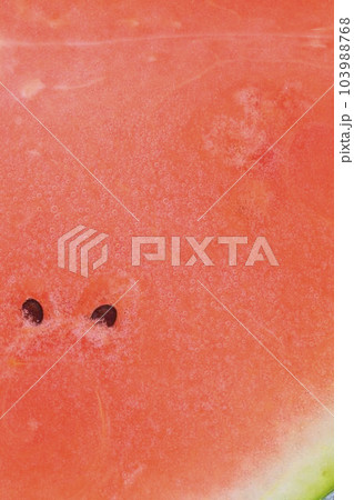 Slice of ripe watermelon in water. Close-up of watermelon in liquid with bubbles. Ripe red melon in sparkling water. Macro vertical image of melon in carbonated water. 103988768
