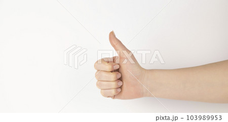 Hand gesture - thumbs up, isolated on a white background. The female palm points to something that is empty for your design. 103989953