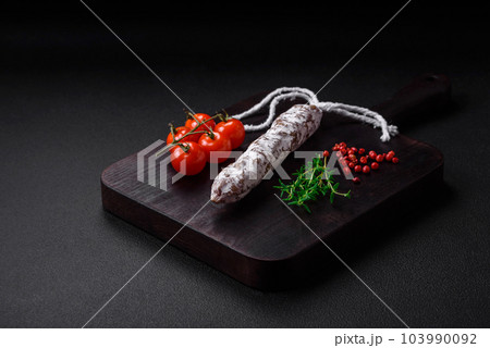 Delicious fresh smoked fuet sausage with salt, spices and herbs Delicious fresh smoked fuet sausage with salt, spices and herbs 103990092