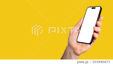 Lodz, Poland May 14 2023 hand holding iphone 14 pro phone mockup, screen mock-up. Yellow banner 103990871