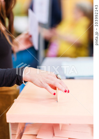 voting democracy background. Unrecognizable hispanic woman hand in candidate election referendum voting democracy background. Unrecognizable hispanic woman hand in candidate election referendum 103992143