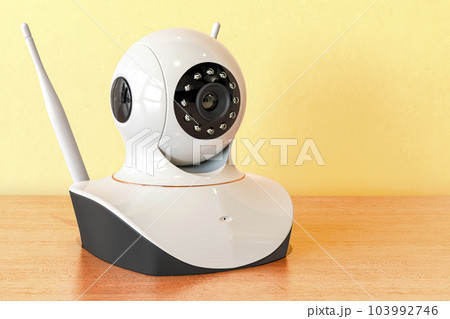 IP camera on the wooden table. 3D rendering IP camera on the wooden table. 3D rendering 103992746