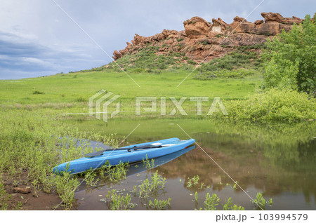 touring stand up paddleboard on a lake at Colorado foothills - Horsetooth Reservoir in late spring scenery touring stand up paddleboard on a lake at Colorado foothills - Horsetooth Reservoir in late spring scenery 103994579