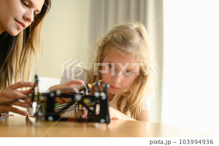 Happy and cheerful family spending good time together at home Happy and cheerful family spending good time together at home 103994936