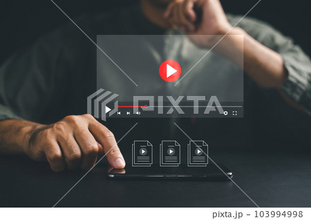 Watch, listen, and relax with a smartphone in hand, indulging in video streaming on a virtual screen. Explore a digital realm of movies, music, and online content from the comfort of home. 103994998