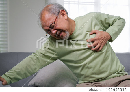 Heart attack symptoms, Senior heart attack suffering indoor Heart attack symptoms, Senior heart attack suffering indoor 103995315