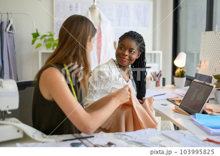 Happy Couple of fashion designer working together in workshop studio 103995825