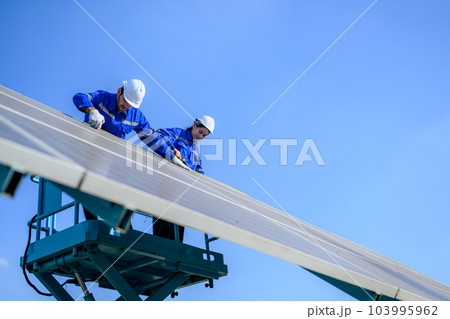 Solar panel station, Engineer installing solar panel at solar energy farm field Solar panel station, Engineer installing solar panel at solar energy farm field 103995962