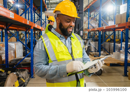 Warehouse workers checking and controlling boxes in warehouse Warehouse workers checking and controlling boxes in warehouse 103996100