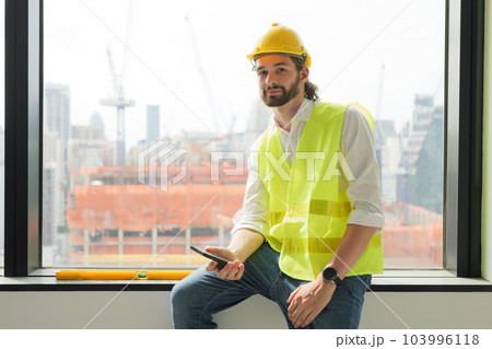 Portrait of smart engineer foreman with safety helmet and vest 103996118