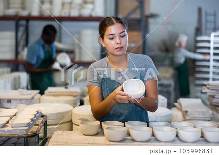 Young woman potter with new crafted ceramic bowls 103996831