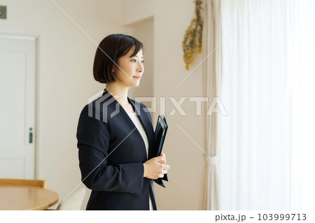 リビングにいるスーツの女性 103999713