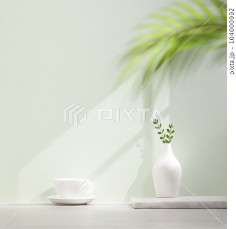 Vases and objects on the table in a warm room with sunlight coming in 104000992